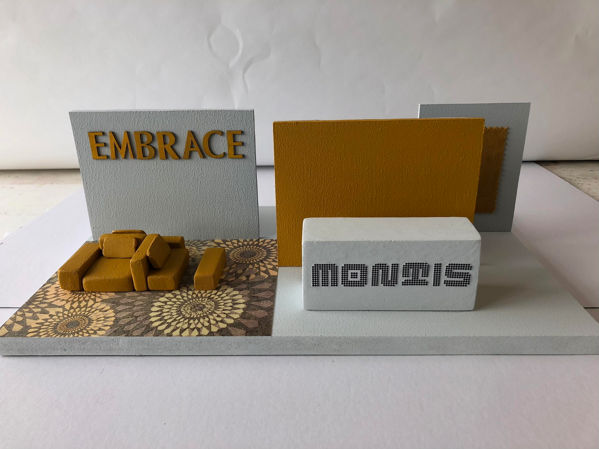 Interior concept board with hand-assembled material samples and warm mustard tones, studying mood, texture and light.