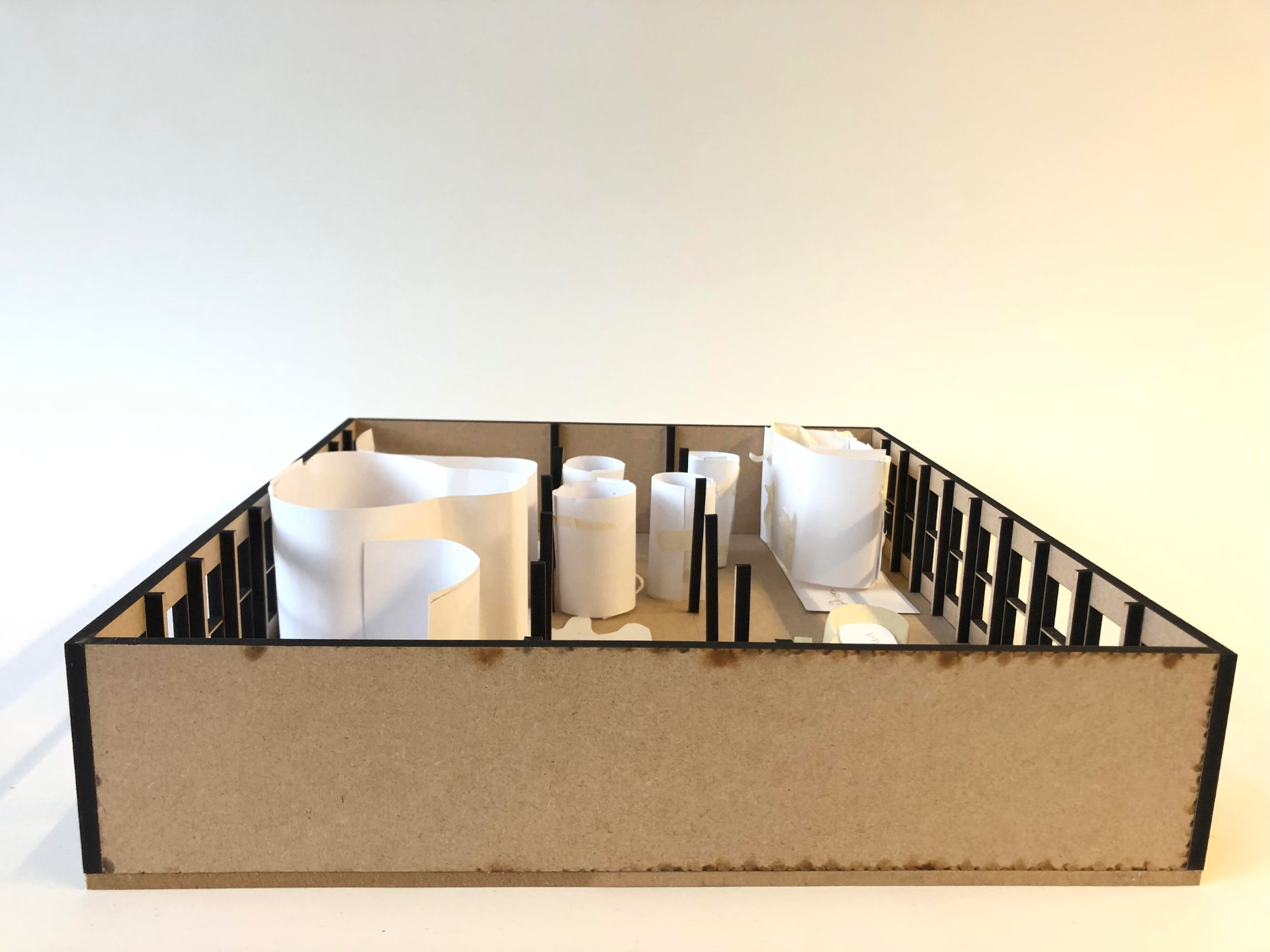 Plan model with soft paper forms mapping zones, circulation and transitions in a room.