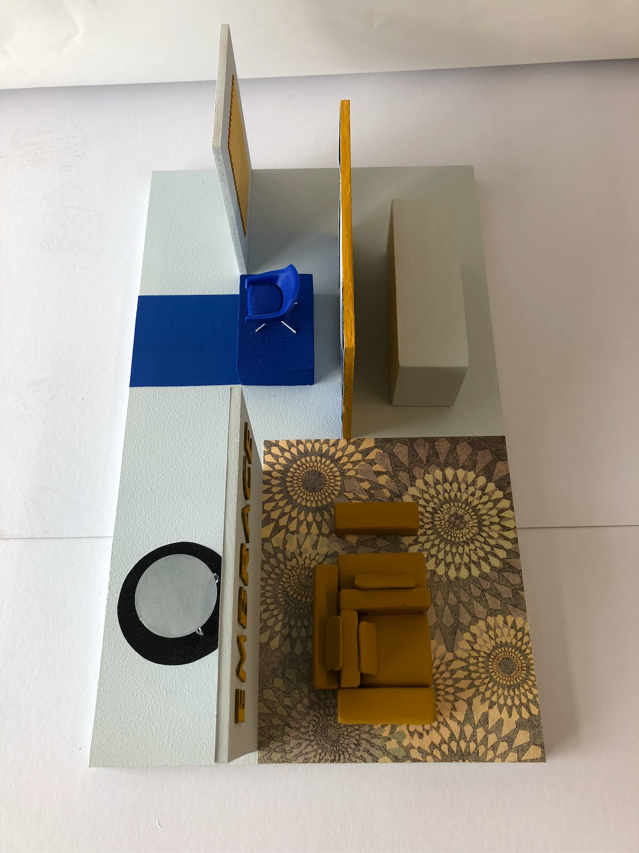 Top-down view of a handcrafted interior model — walls, floors and miniature furniture all built by hand — studying mood through color, texture and light.
